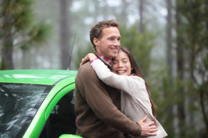 Couple driving in green car in love on travel