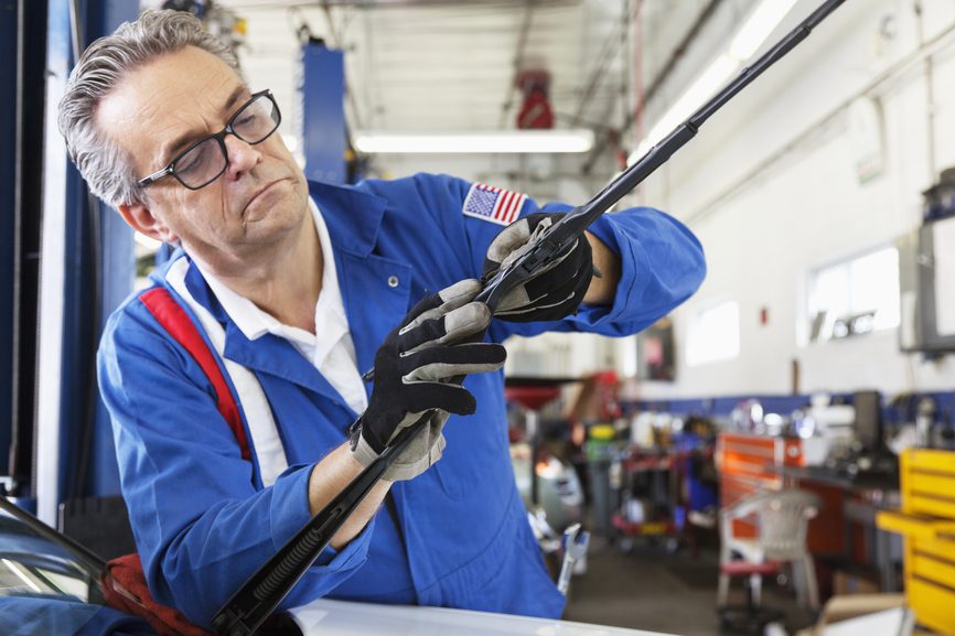 When drivers ask how to replace windshield wipers, they are often referring to the wiper blades only. Wiper blades are made of rubber, which has limited life under the harsh weather conditions of northern Utah. Consequently, blades should be replaced once or twice each year (spring and fall) for safety. This can be a daunting proposition for some, but with these simple tips, you can handle this important task easily and quickly. Which Windshield Wipers to Choose Choosing the right wiper blades for your vehicle is half the battle. Select the highest-quality brand available to ensure your safety in bad weather conditions. Your car’s owner’s manual may provide the size and arm type. Alternatively, most blade manufacturers offer an online search tool. Auto parts stores may also have reference catalogs, organized by auto year, make and model. The safest way to be sure you get the right blade length and arm type is to check with a trusted auto repair shop in your area. Many cars require a different blade for each wiper, so be sure to look for both driver and passenger side specifications. Experts suggest buying two sets of blades, and always keeping one in the trunk for emergencies. Wiper Blade Removal Windshield wiper arms typically have three segments: the lower arm attached to the car below the windshield, the upper arm and the blade assembly that attaches to the upper arm. Examine your new blades for an easy way to know what you’re looking for. Gently lift the wiper arm away from the windshield (be careful with older models however, as they may not lift out the way newer cars do). Hold the arm with one hand at all times to make sure it doesn’t snap back down unexpectedly. Look for the hook or pin that holds the blade and gently press the rubber stopper that holds it down. The old blade should release. Installing New Wiper Blades Place the new blade onto the upper arm assembly. Wiggle the blade gently into place (you’ll feel a little snap when you have it right), replace the rubber stopper and place the arm back onto the windshield. Repeat with the other side, and test for correct operation. Newer blade designs have started to pop up, including a frameless style. If you have any trouble selecting or installing your new wipers, play it safe and call on a professional. In the Sandy and Salt Lake areas, Emission Time’s experienced technicians can help you with maintenance and repair as well as on-the-spot registration renewal. They can even help you learn how to replace windshield wipers on your vehicle!